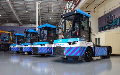 Gaussin logsitics equipment, bright blue, black, and white in color, lined up in a row