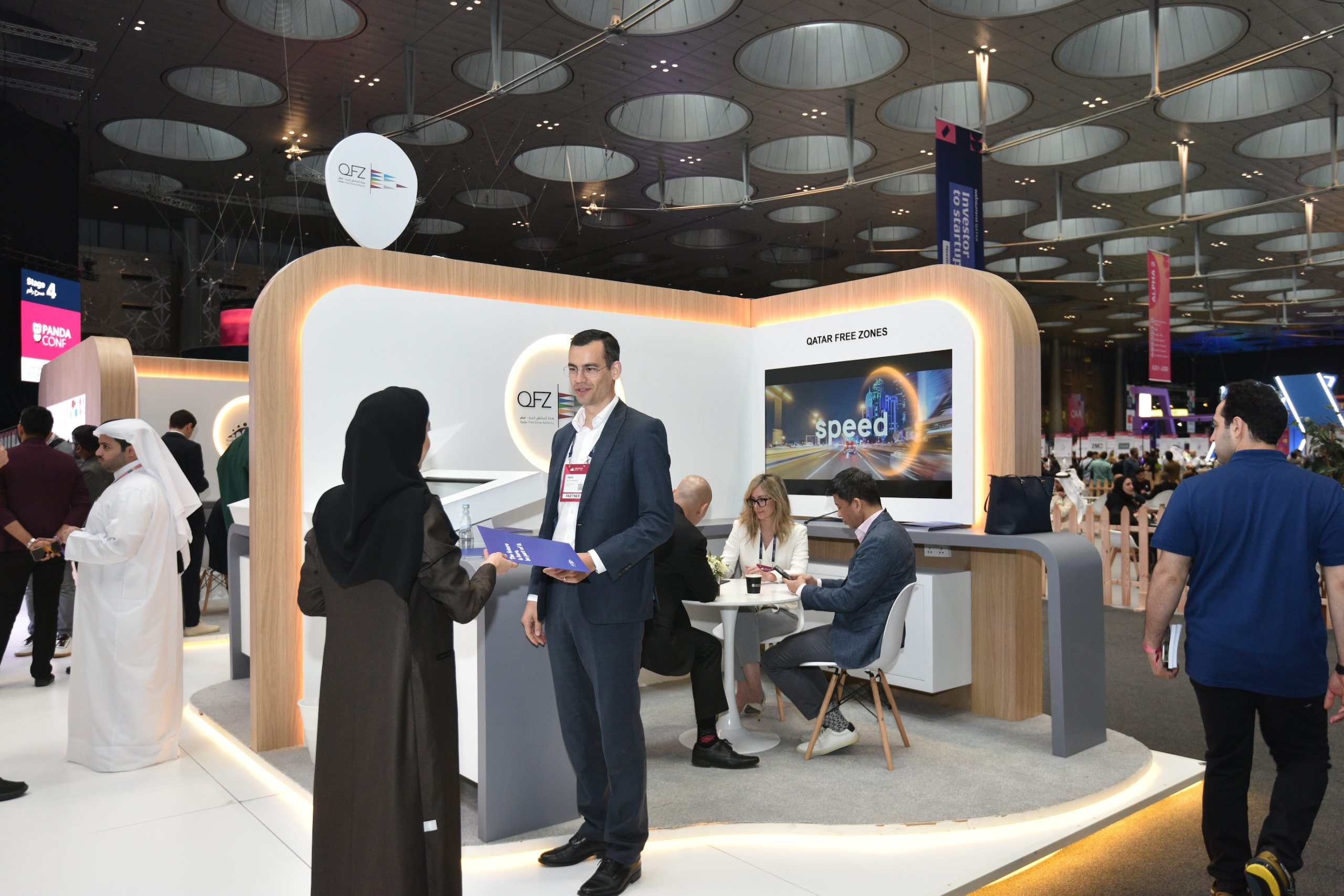 Lively business discussion between two men, one in traditional Arabic clothing and one in a suit